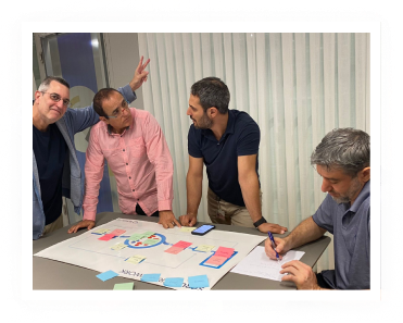 4 men working together while studying