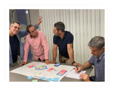 4 men working together while studying